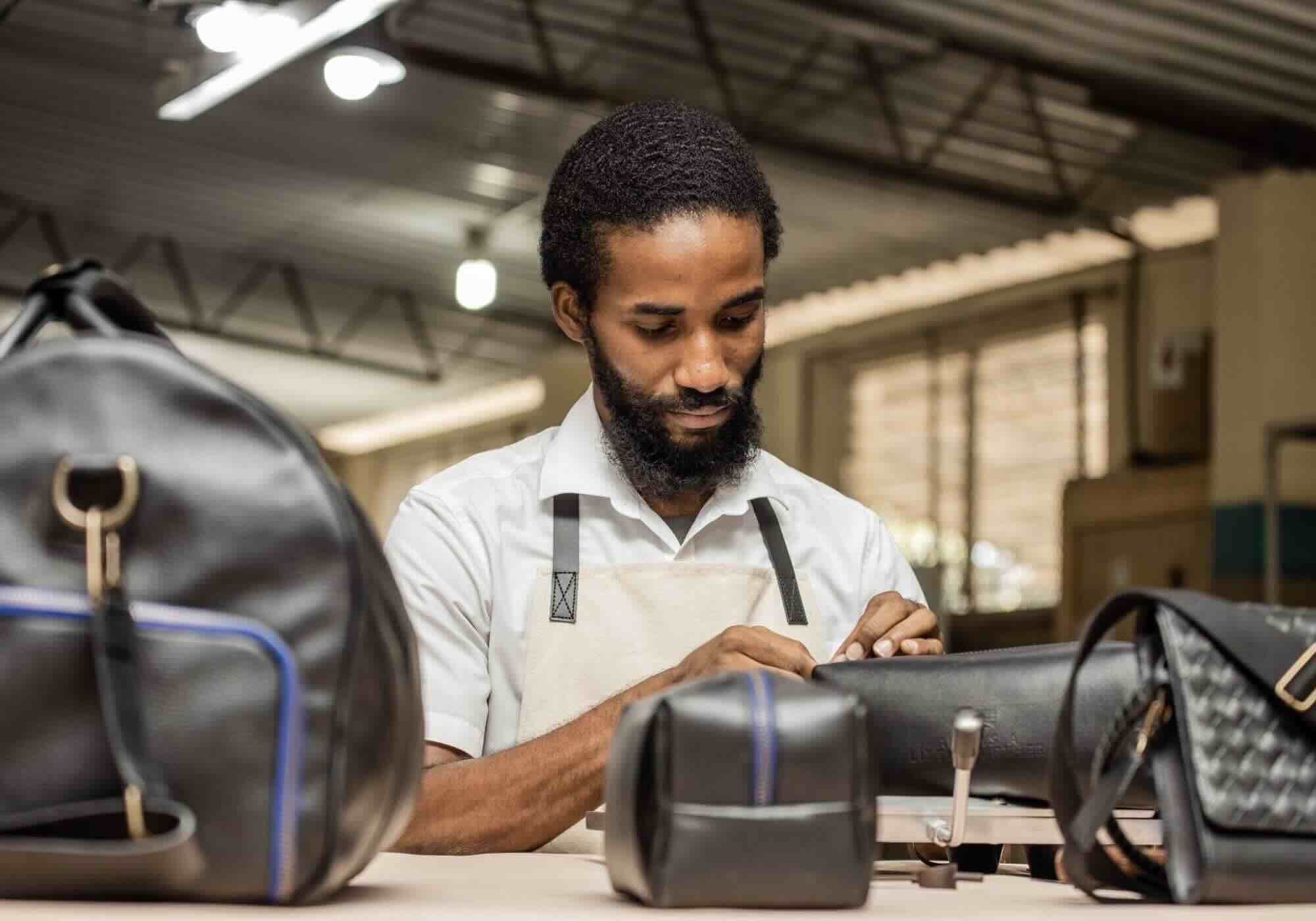 Billy Collection artisan working on leather bag