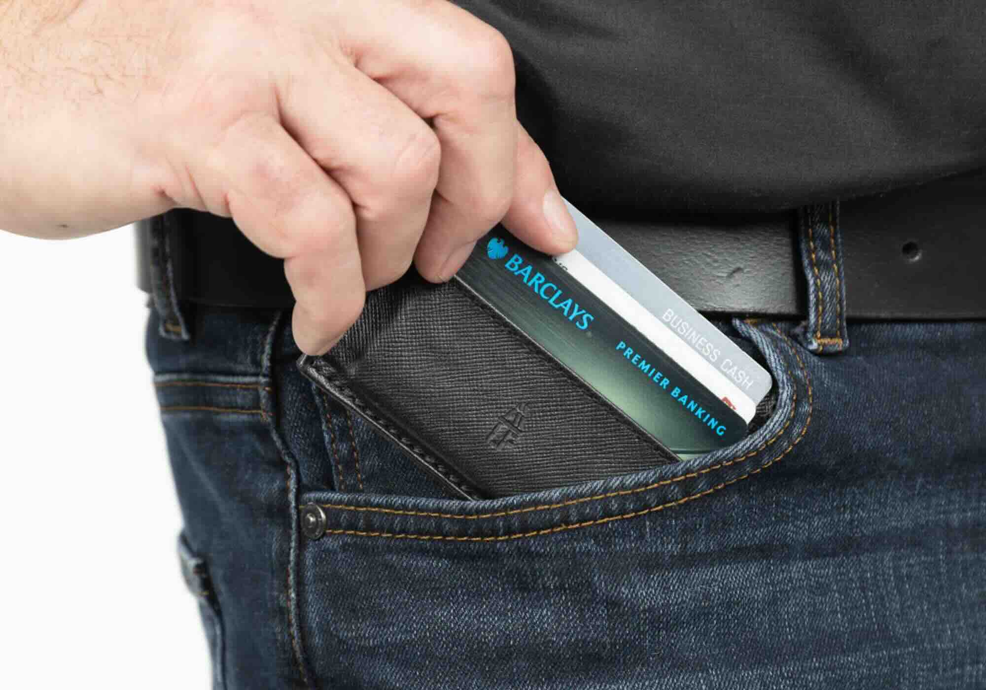 Man putting Barclays card in pocket