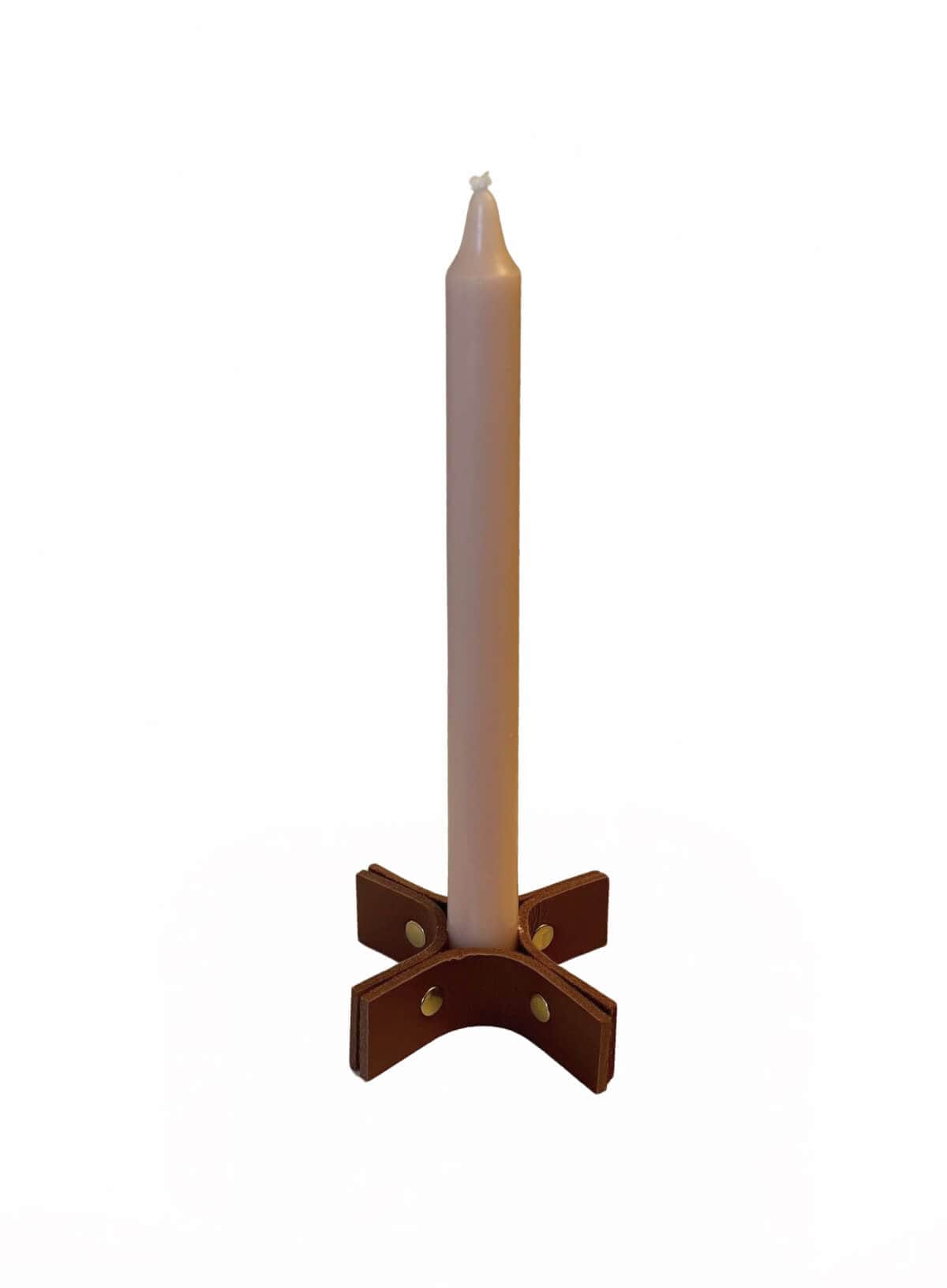 White candle in a brown leather holder on a white background