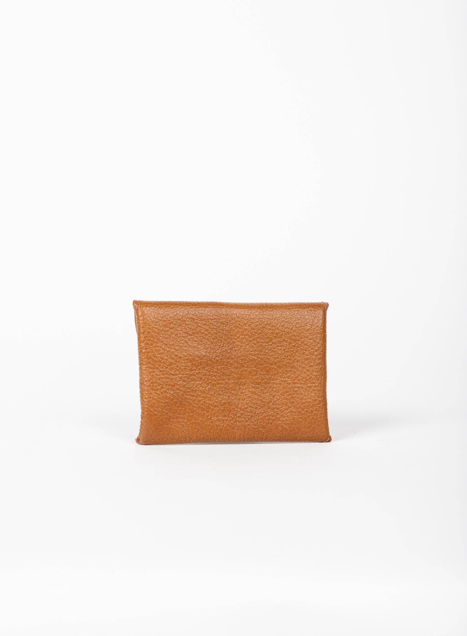 Cognac leather coin pouch on a white background