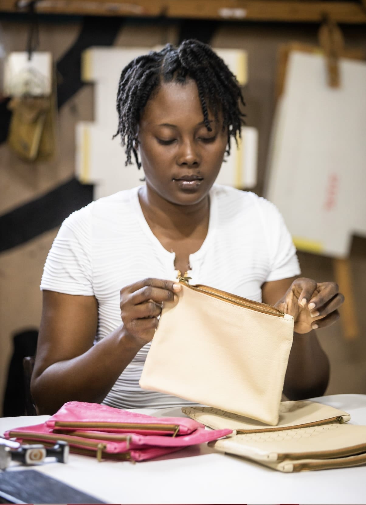 Artisans working on pouches in factory