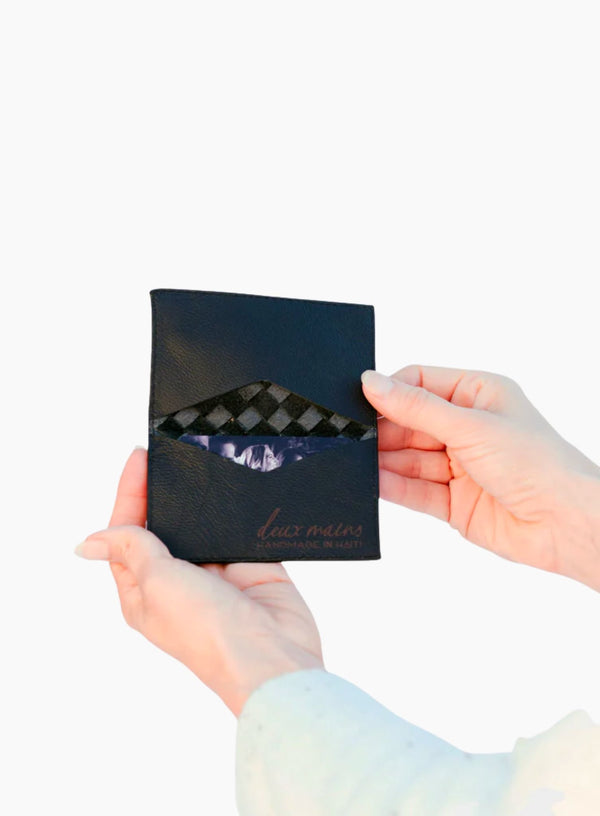handwoven leather card holder in black with a close-up showcasing interior details by model.