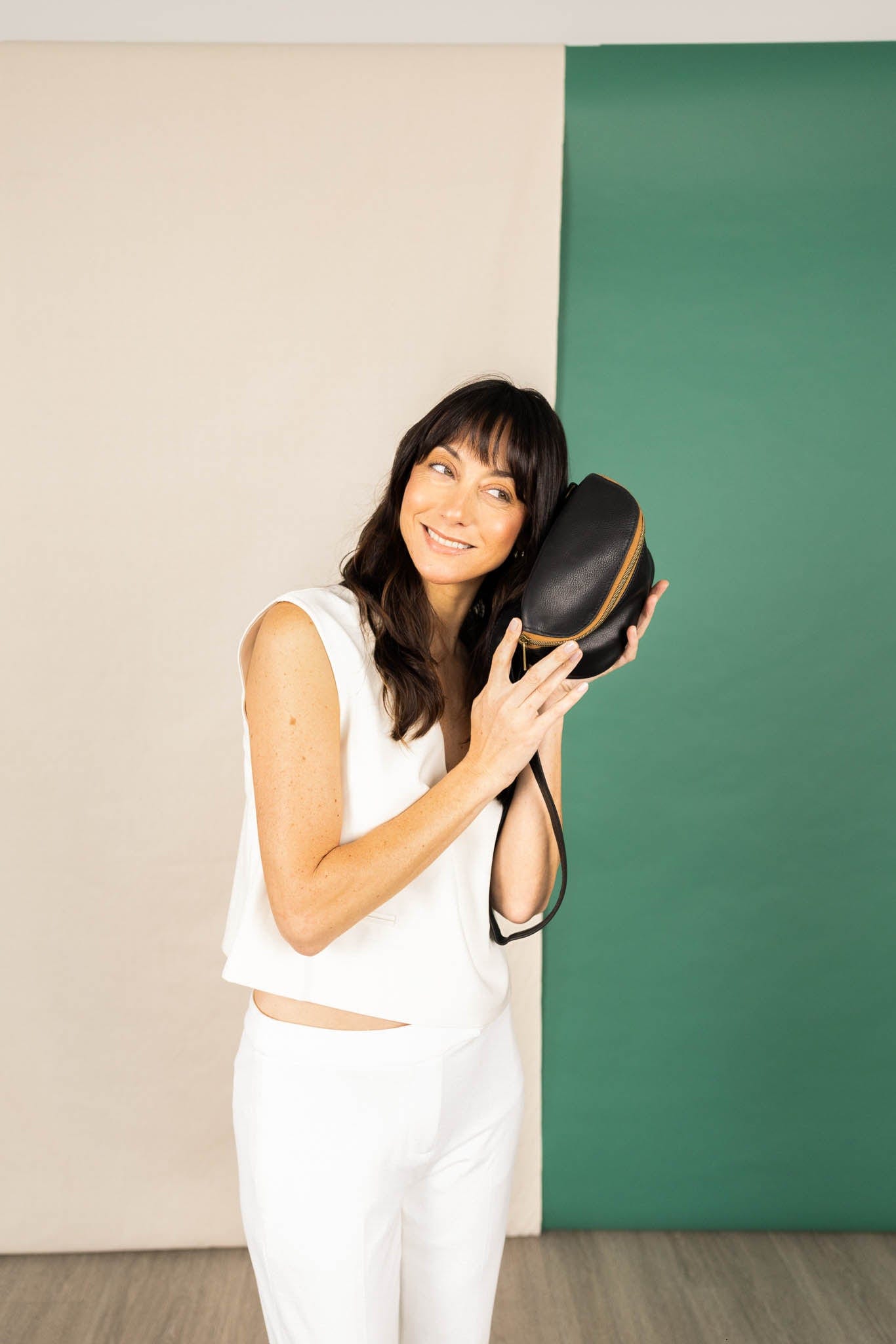 Hip bag in black from the fall/winter collection held by a model.