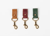 key chain for christmas present from ethically crafted accessories in multiple leather colors  and gold coated metal showcasing front view. 