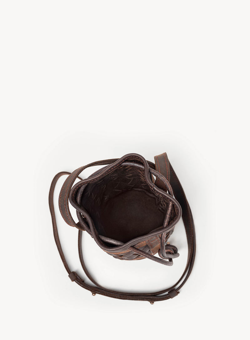 Mini essential bucket bag from womens bag collection in brown showcasing interior view.