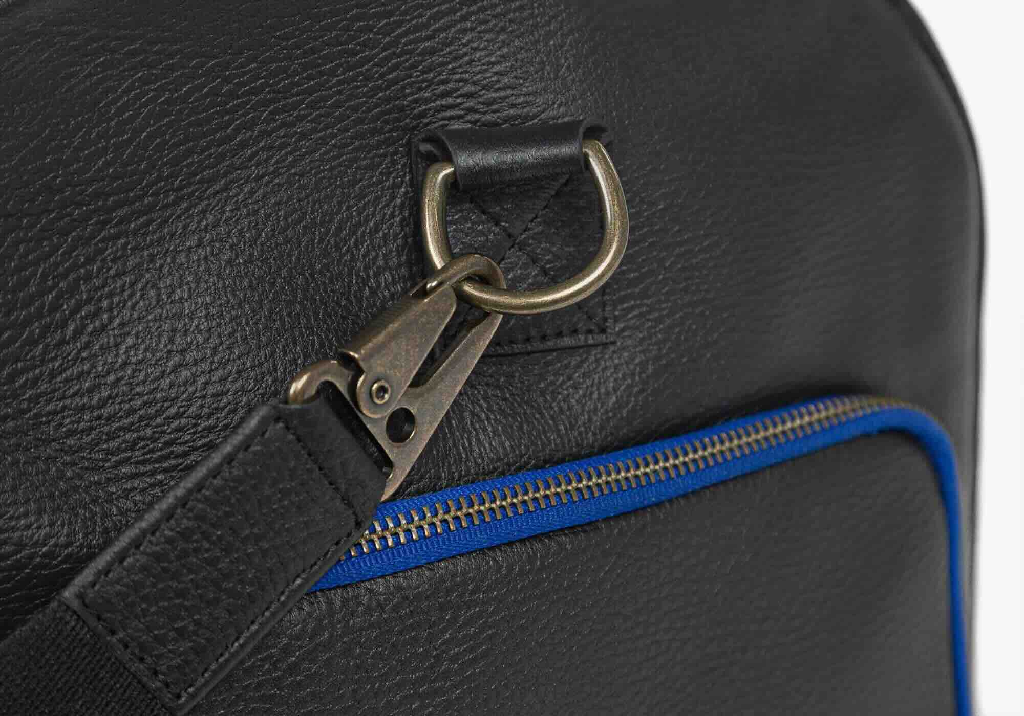 Mission-essential duffle bag strap attachment with blue stitching