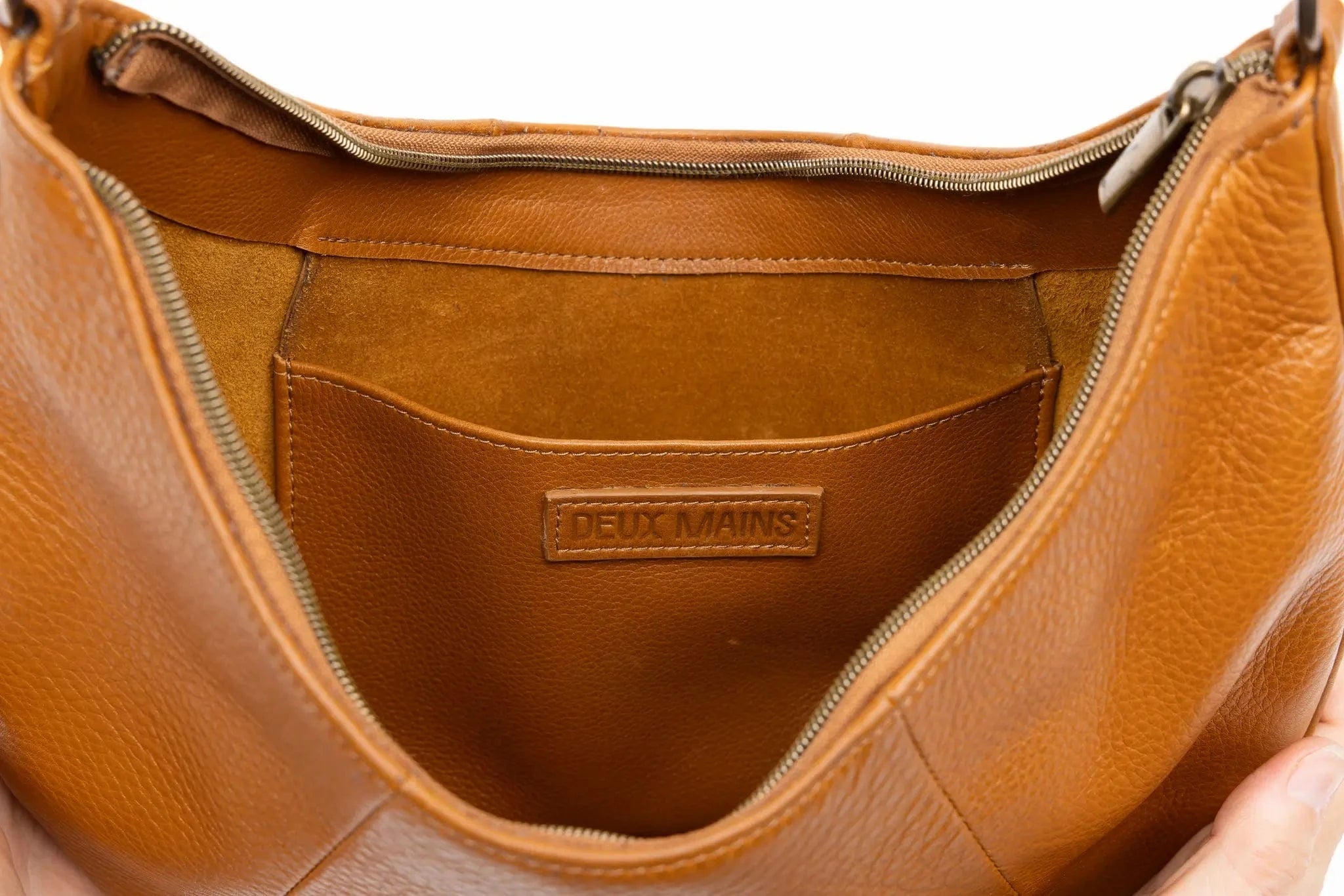 Honey leather handbag with 'Deux Mains' logo on a white background