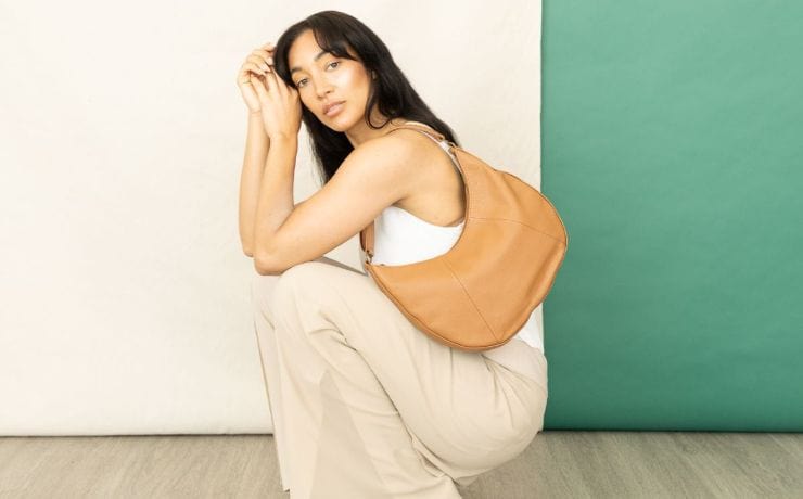 Woman with honey-colored saddle shoulder bag, Summer Collection