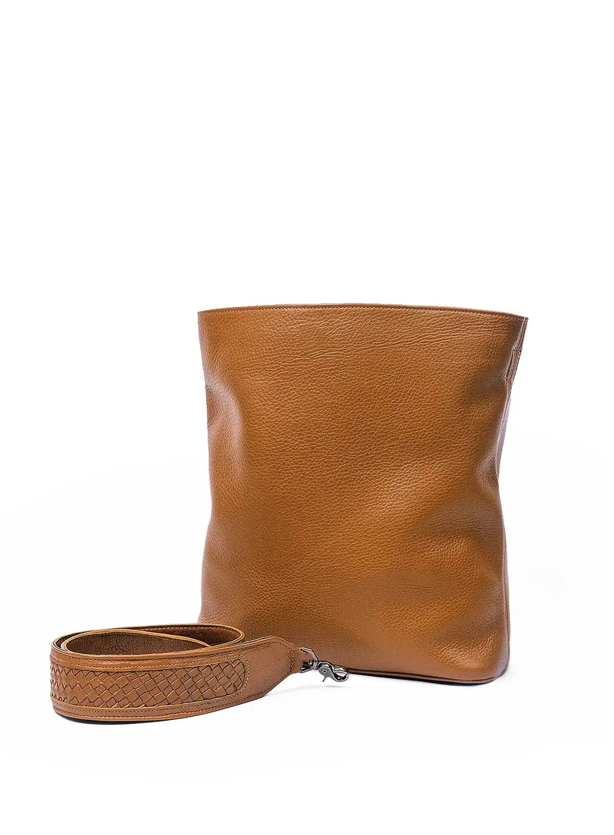 Cognac leather bag with a strap on a white background