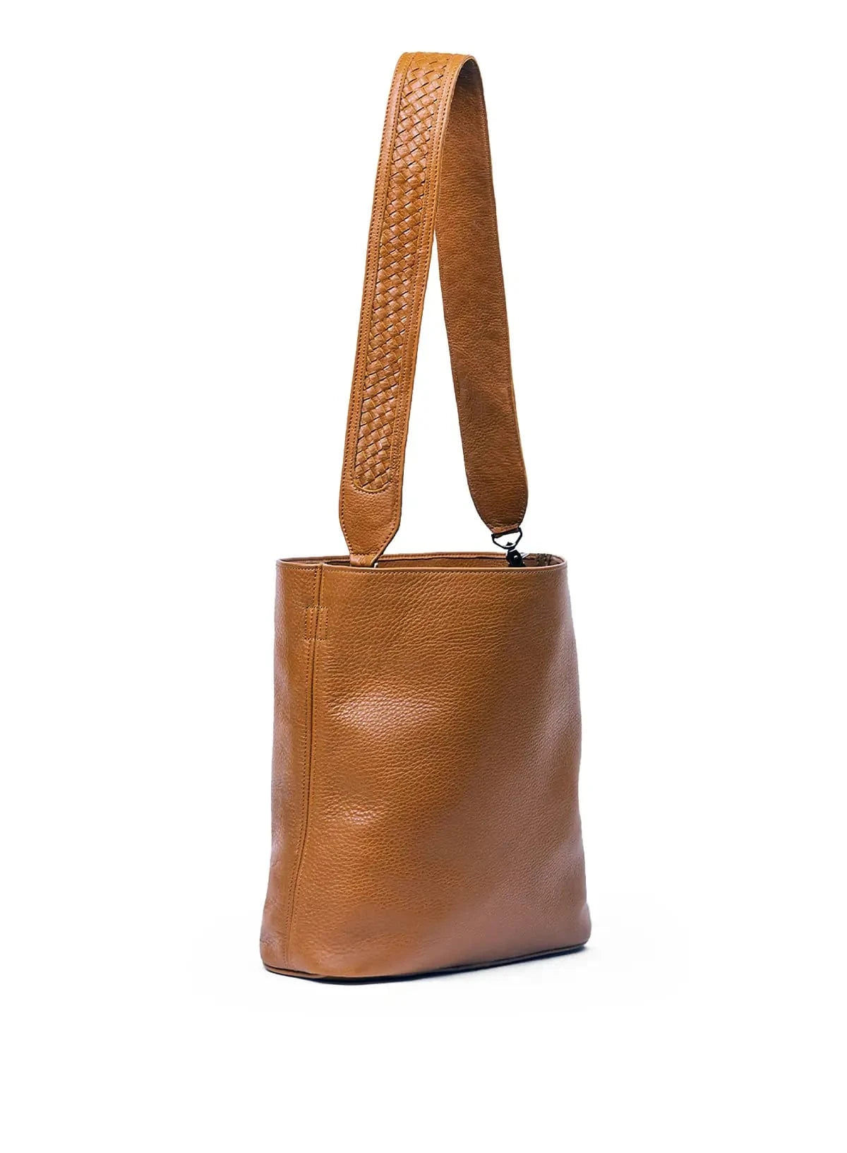 Cognac leather handbag with a woven strap on a white background