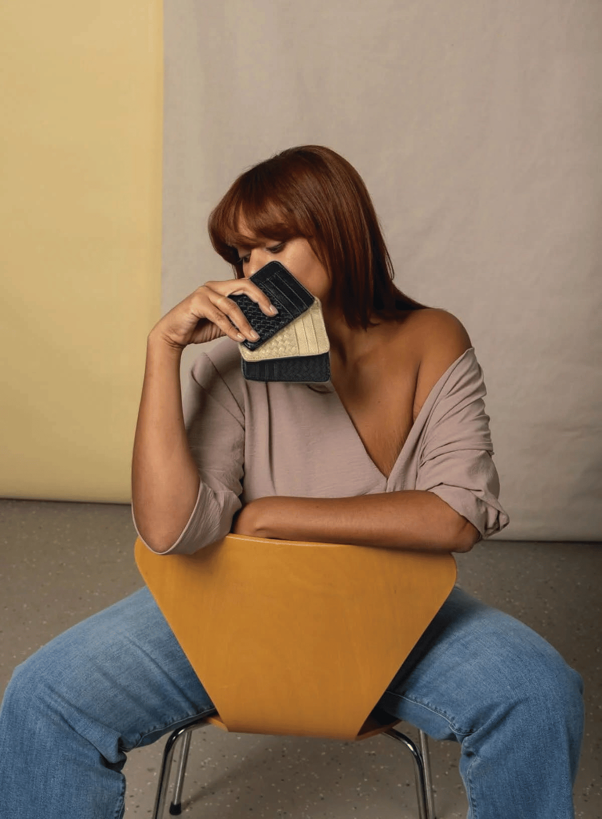 slim id in bone and black held by model sitting.