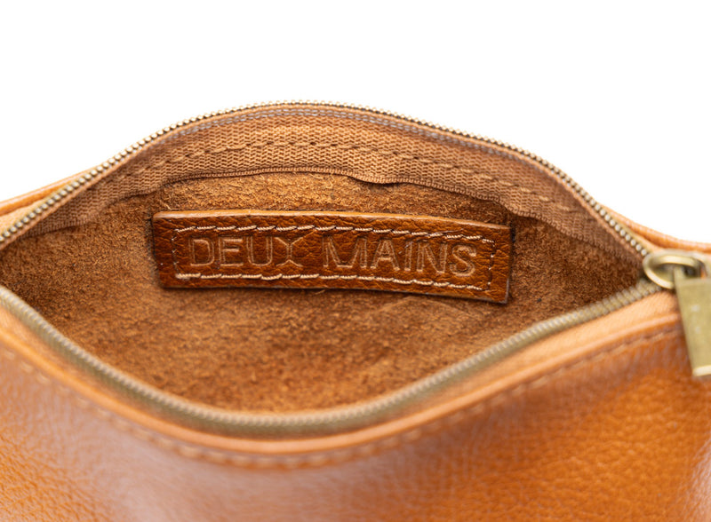 small pouch from ethically crafted accessories in cognac showcasing interior view.