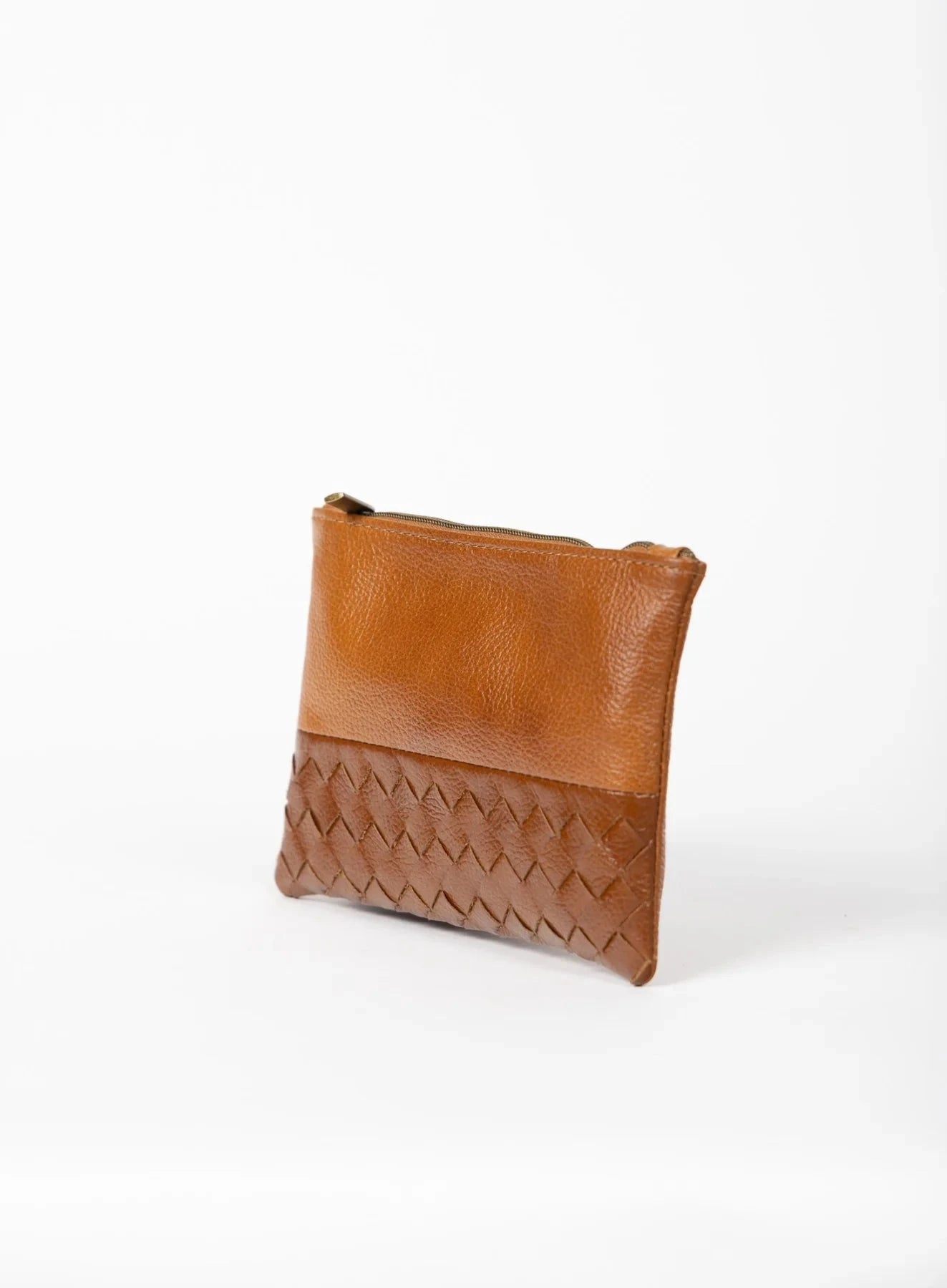 Cognac leather pouch with woven detail on a white background