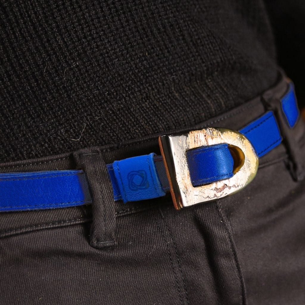 Blue belt with a gold buckle worn by a person in black outfit