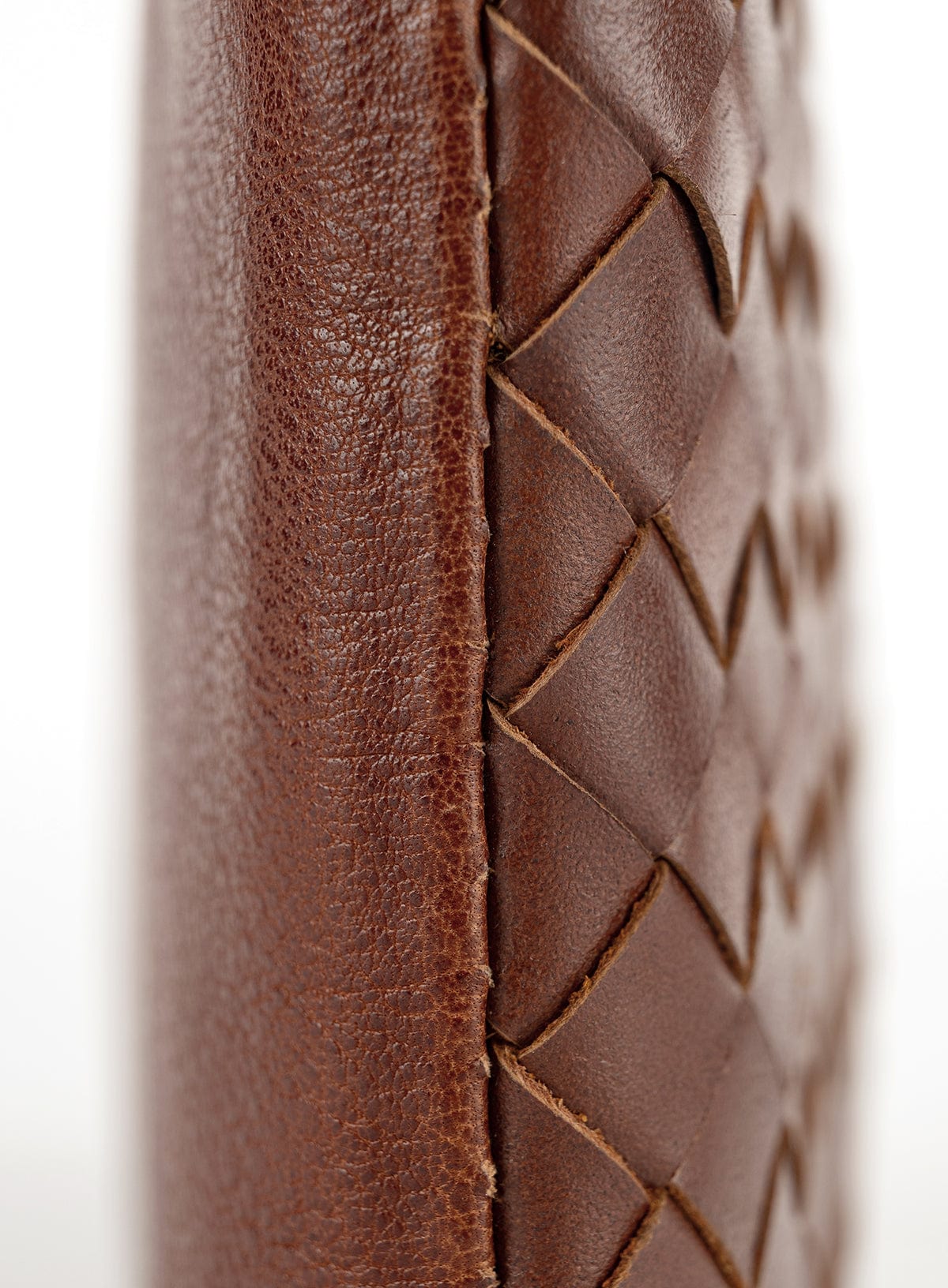 Woven crossbody bag and clutch details on a white background