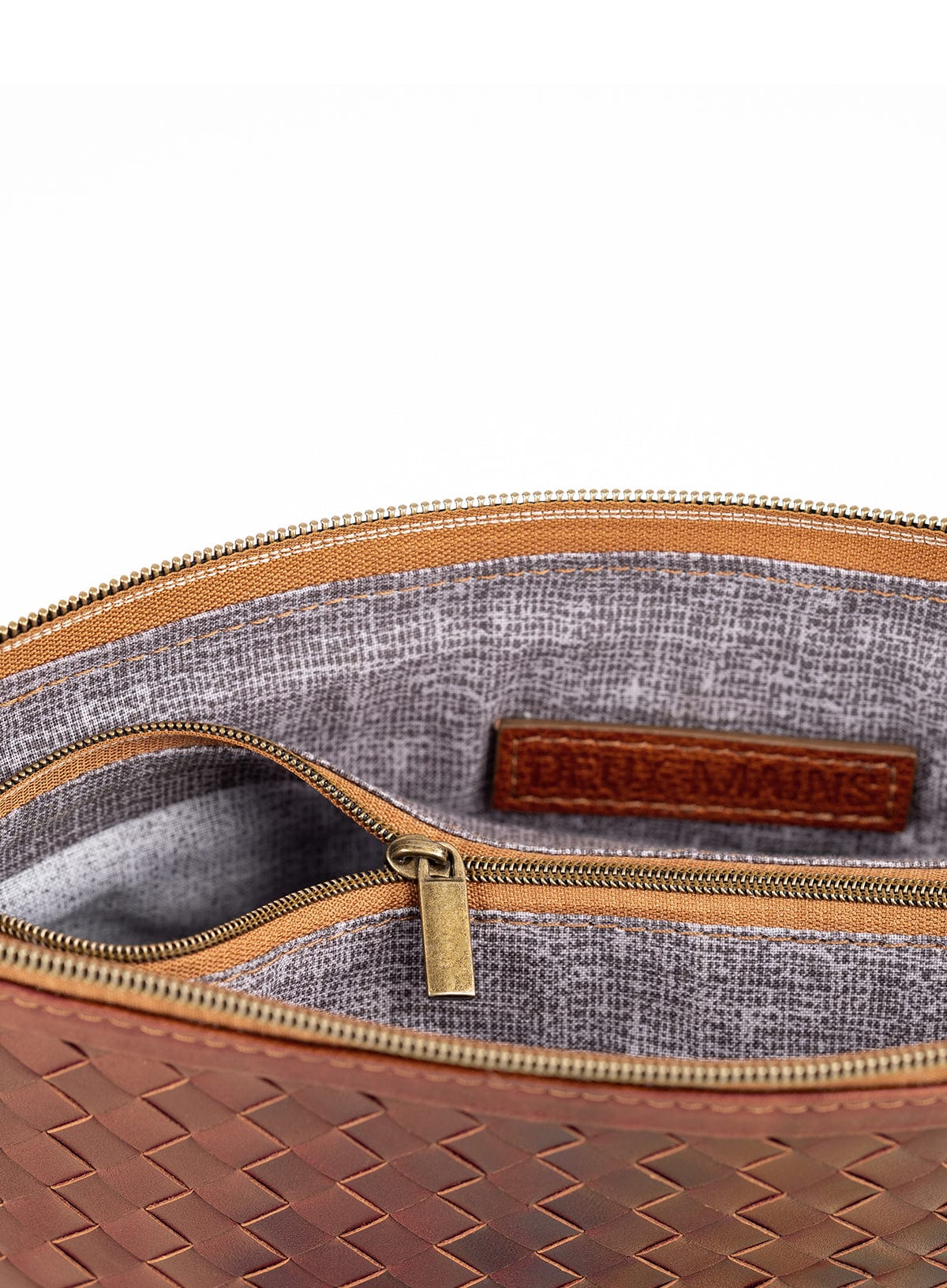 Brown woven handbag and clutch interior on a white background