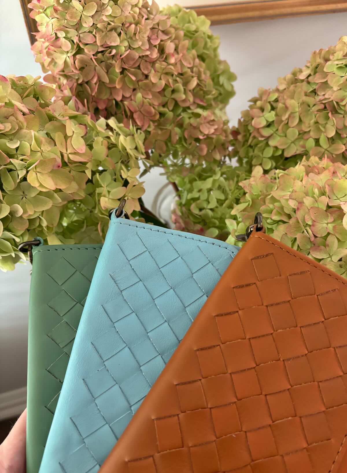 woven wristlets in different colors in front of flowers