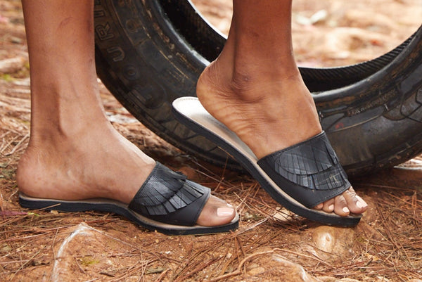 lady wearing our sandals made out of recycled materials.