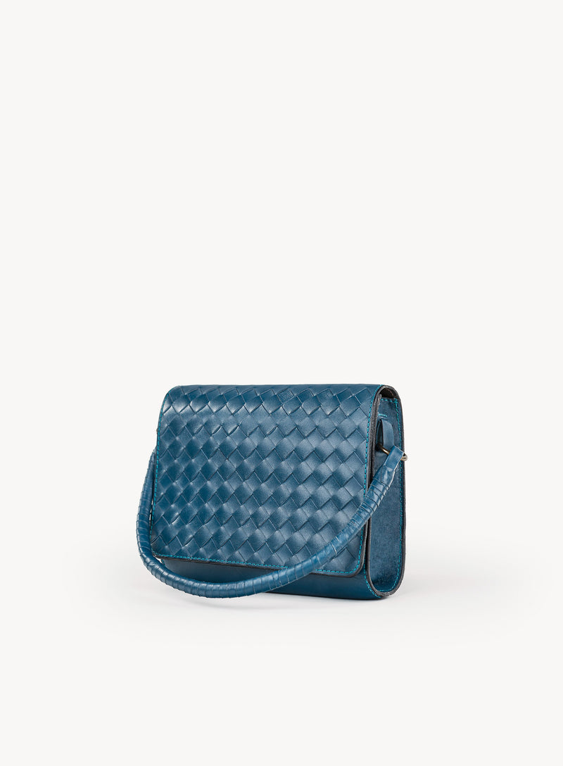 Ideal Crossbody with leather wrapped handle on womens weaved handbag in blue showcasing side view.