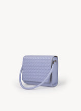 Ideal Crossbody with leather wrapped handle on womens weaved handbag in lilac showcasing side view.
