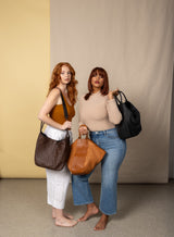 all day leather tote in black brown and black from our fall collection showcased by models in different angles.