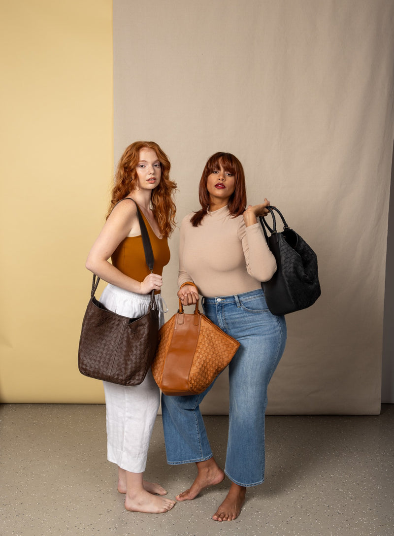 all day leather tote in black brown and black from our fall collection showcased by models in different angles.