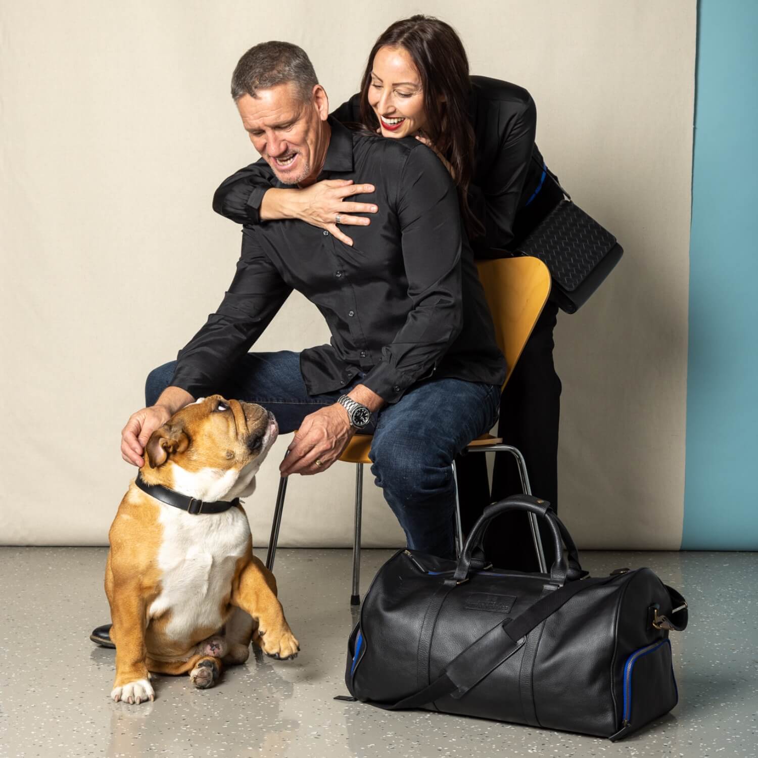 billy and julie in the billy x collaboration photoshoot with their dog alfie and the duffle bag from the collection.