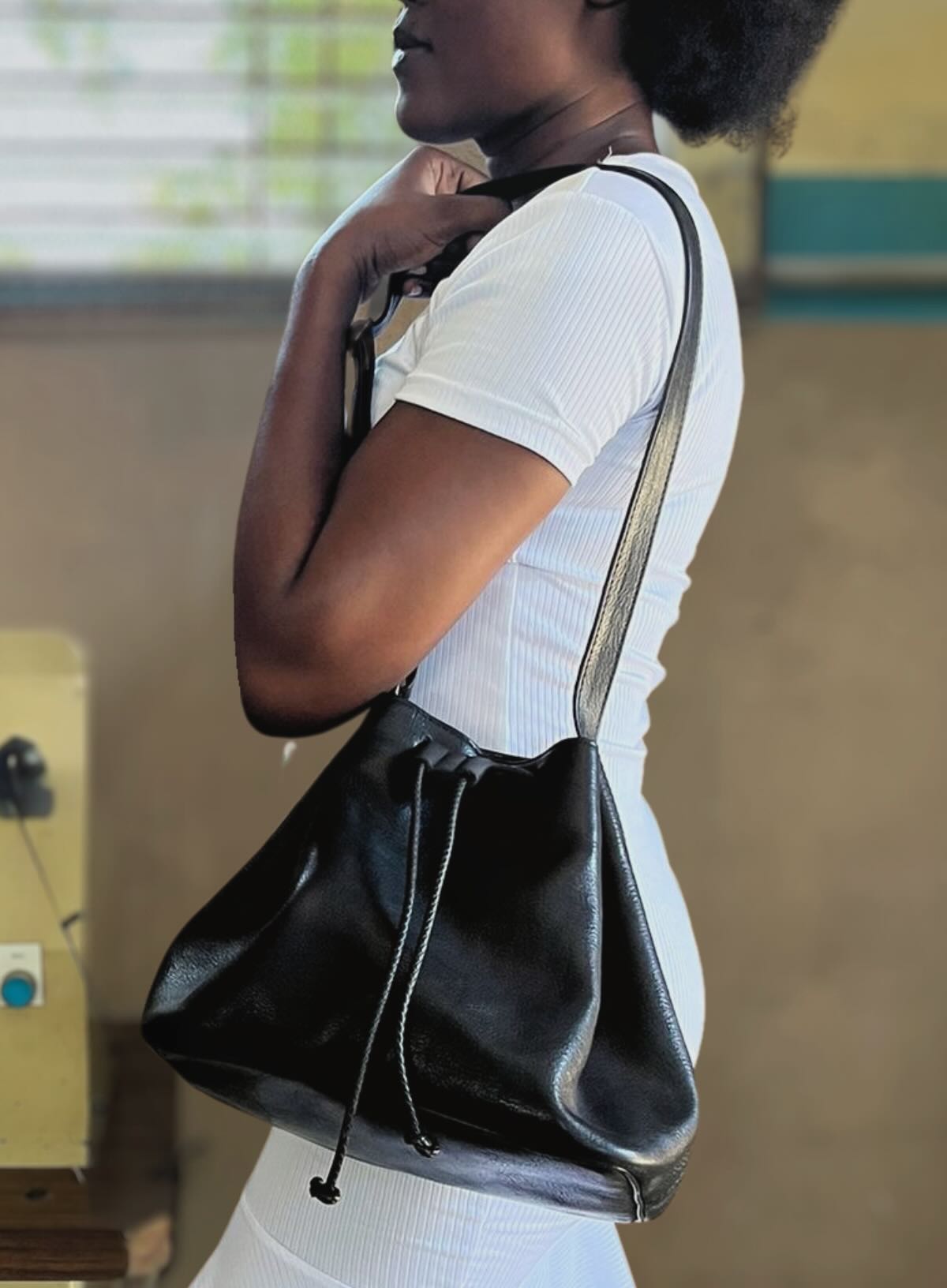 womens leather bucket bag in black from fall collection showcased by haitian artisan in our solar powered factory in haiti.