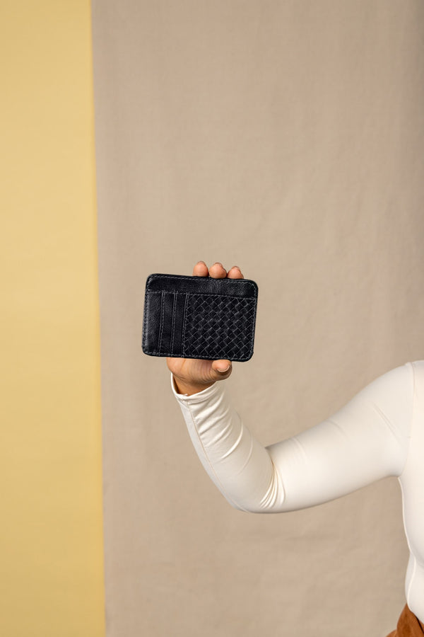card holder in black from the women's spring collection held by model - front view.