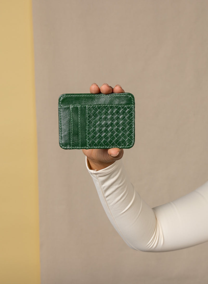 card holder in green from ethically crafted accessories held by model showcasing front view.