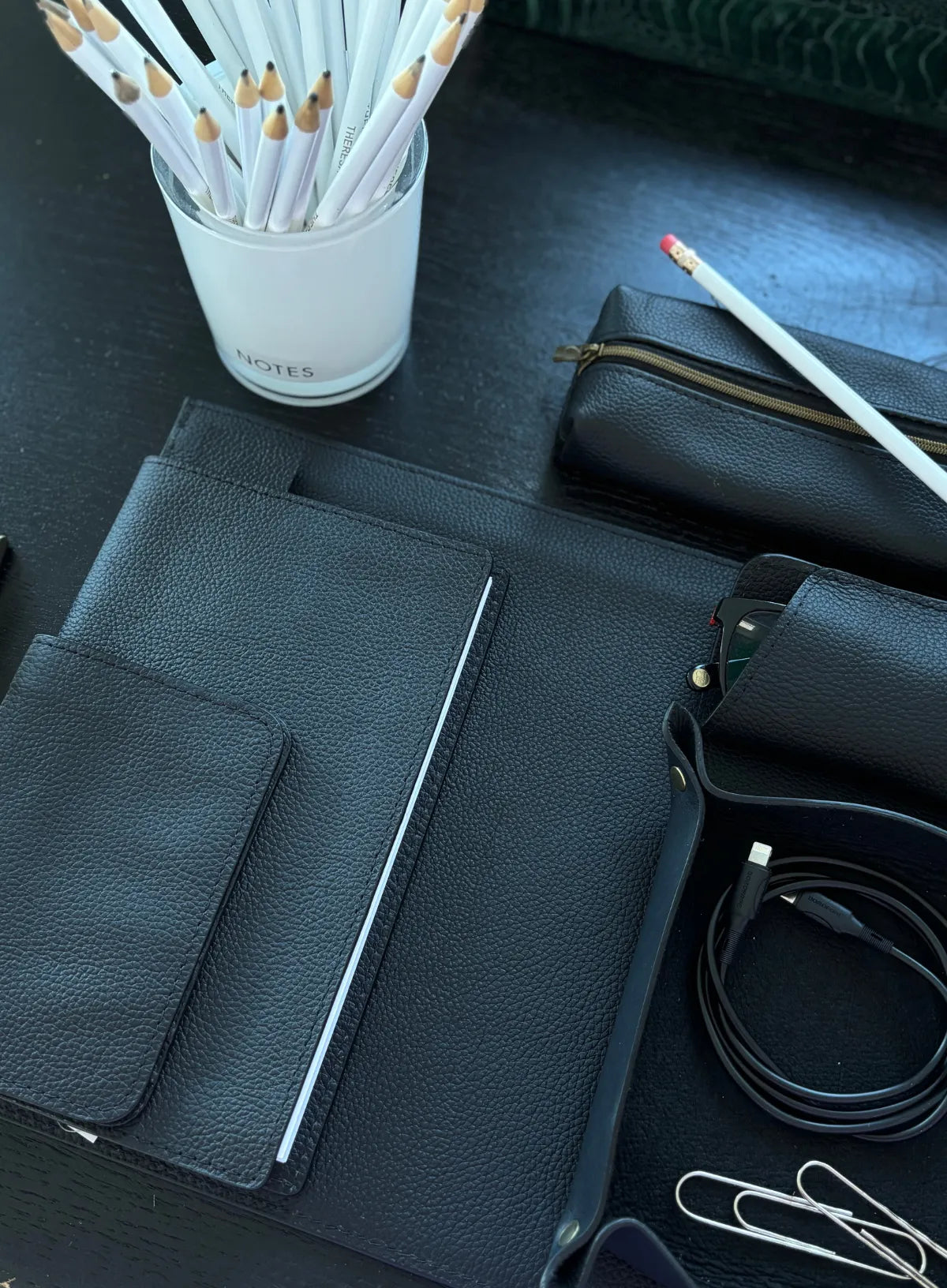 Black leather corporate goods close up with pencils