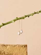elene teardrop earrings in nature inspired setting on a branch.