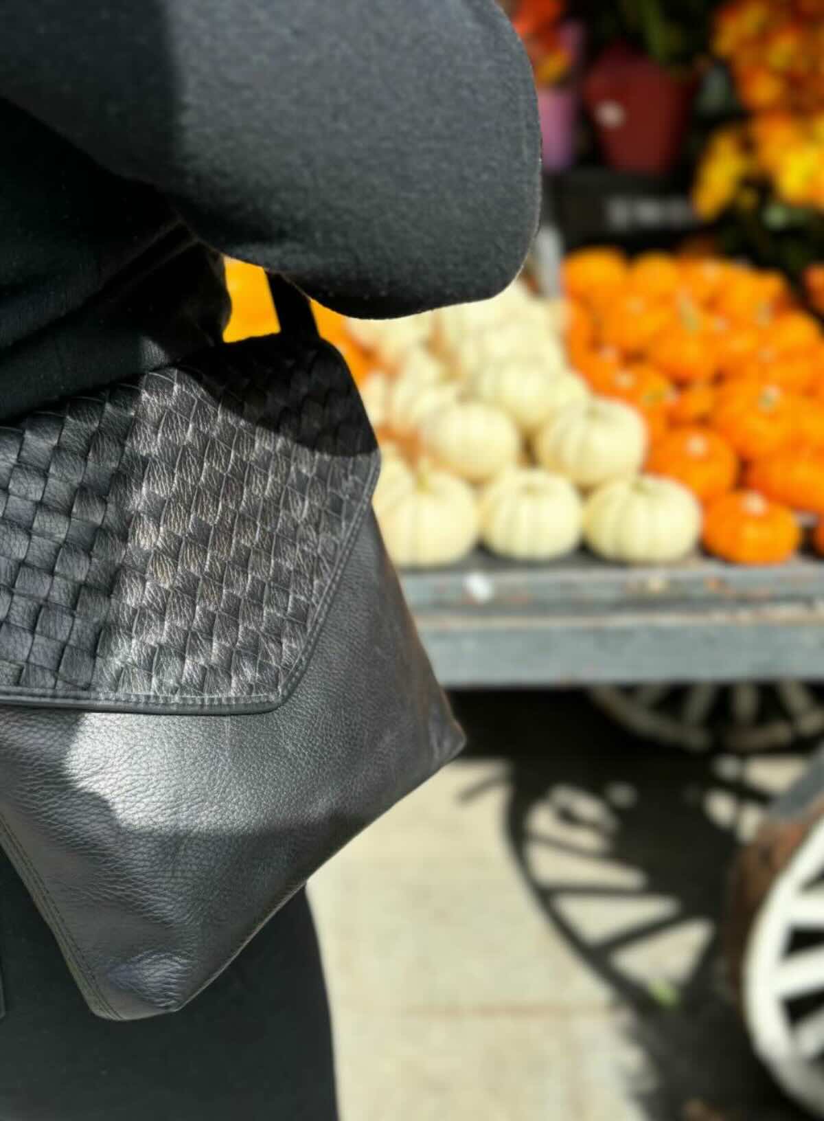 envelope crossbody in black from our spring/summer collection with flowers and pumpkin stand.