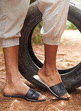 Fringe slide sandal from the sandal collection in black showcased by model walking.