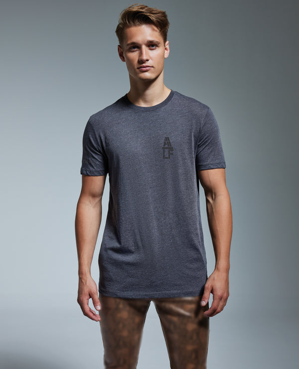 alf t-shirt left chest logo in grey worn by model - front view.