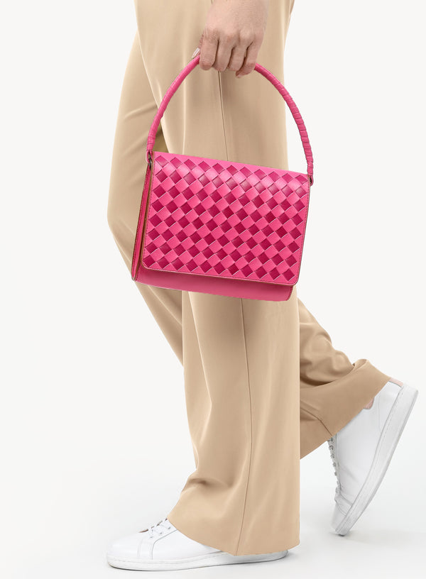 ideal crossbody in fuchsia for spring sale model walking with handbag side - view.