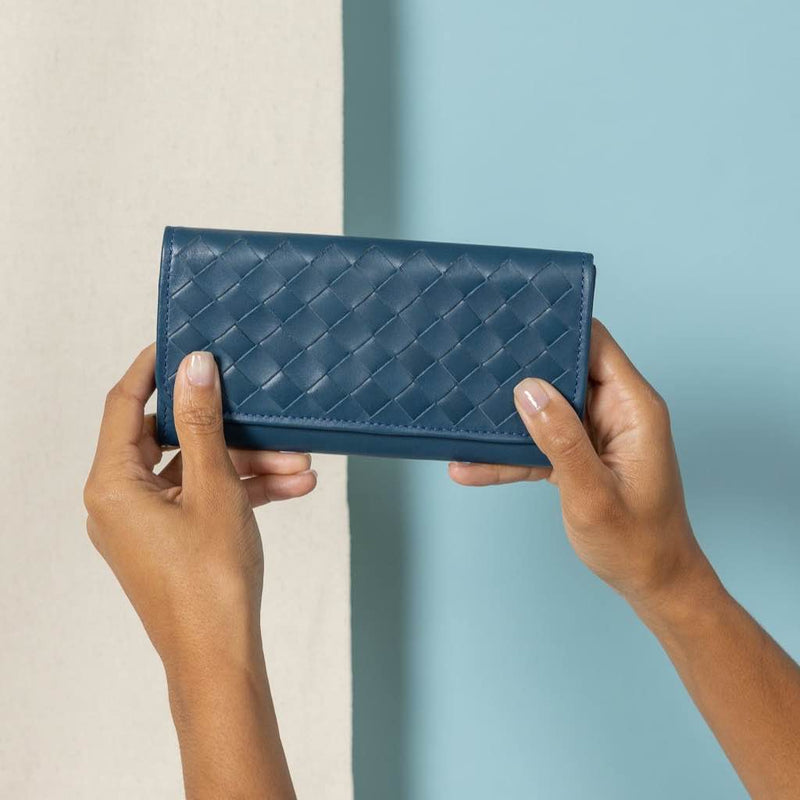 Classic Taupe Trifold Wallet showcasing front view in blue held by model, a timeless and functional accessory for your everyday essentials.