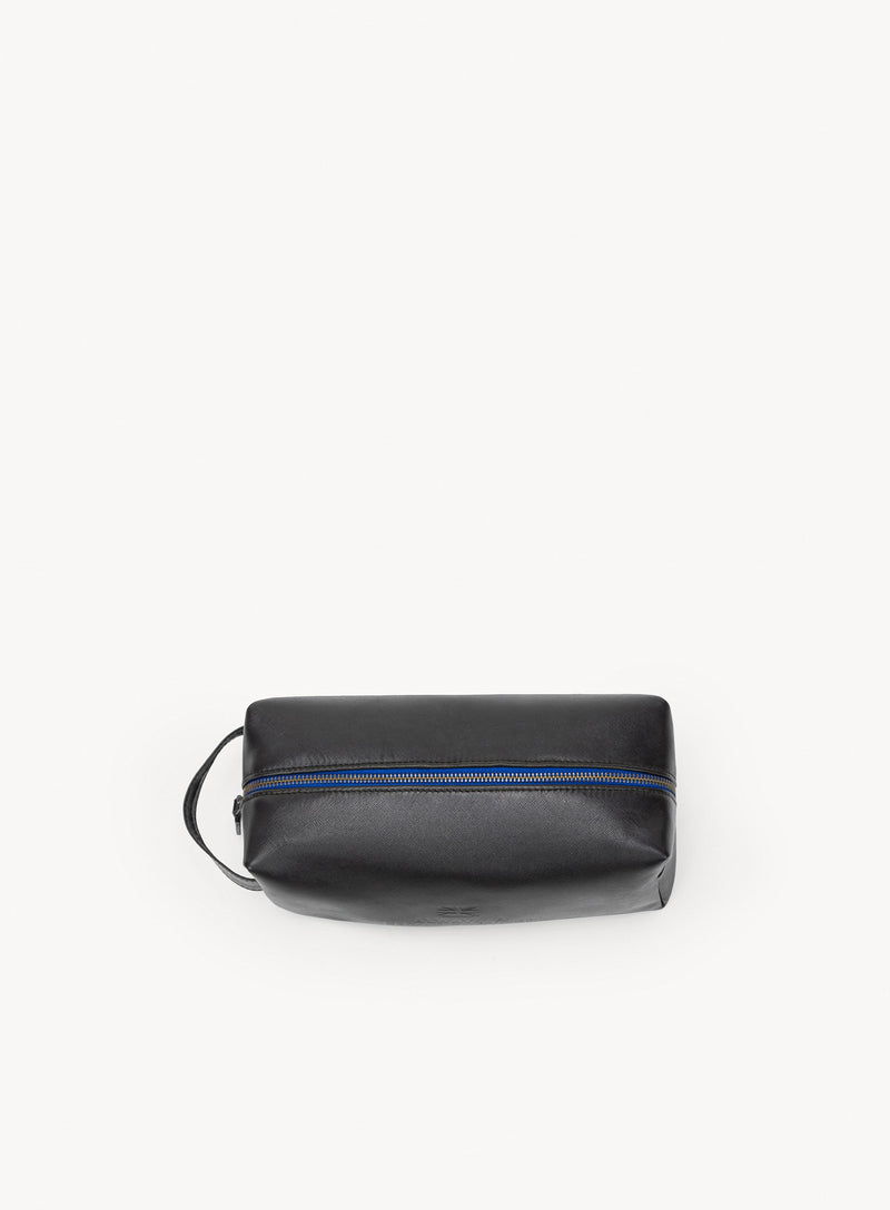 iron tight toiletry bag in black showcasing blue stitching and handle exterior-view.