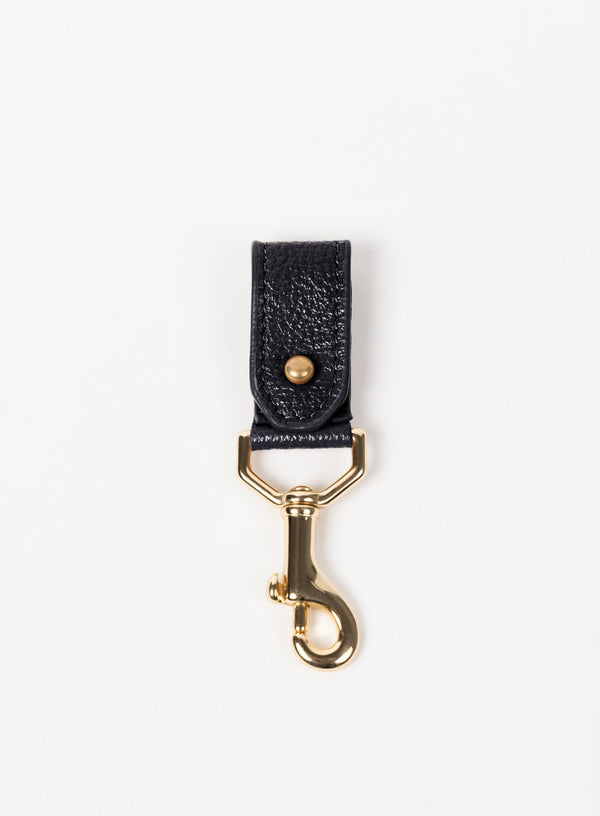key chain from our ethically crafted accessories in black leather and gold coated metal showcasing front view.