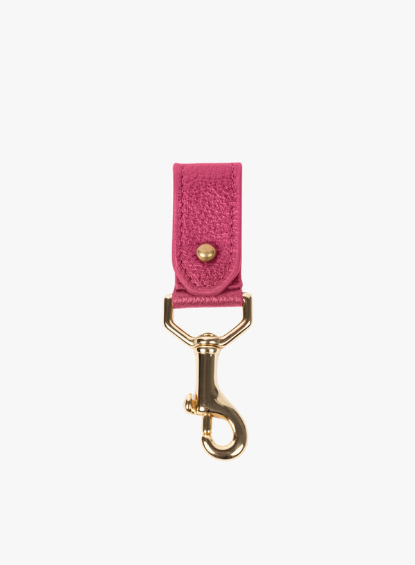 key chain from our ethically crafted accessories in pink leather and gold coated metal showcasing front view.