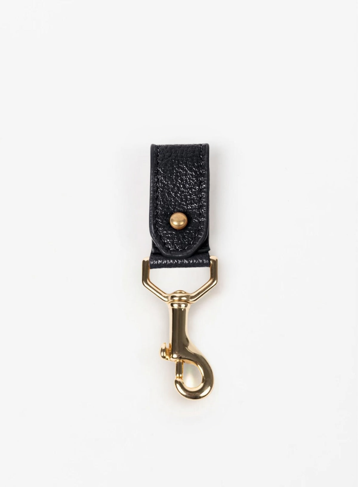 key chain from our ethically crafted accessories in cognac color leather and gold coated metal showcasing front view. 