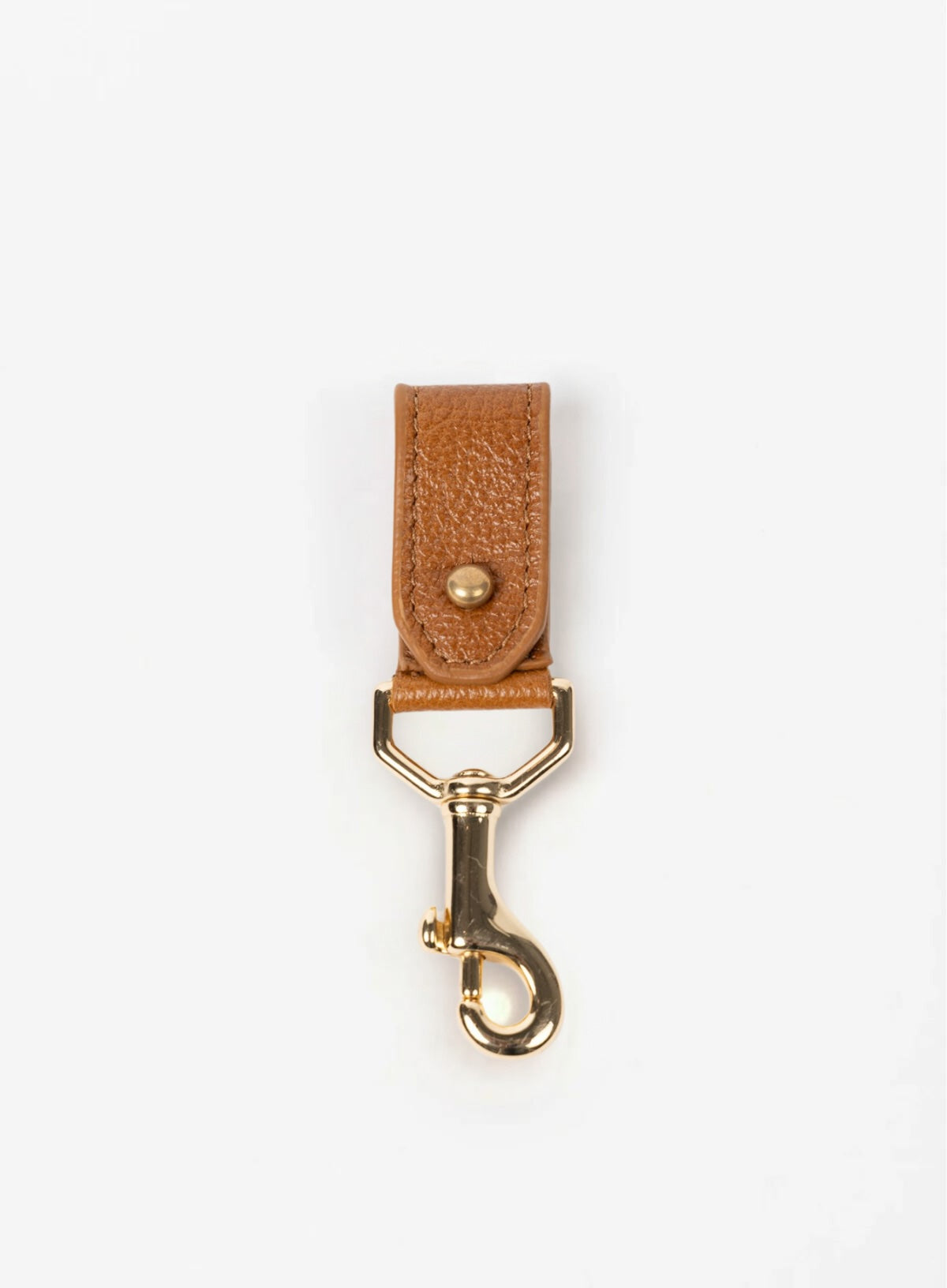 key chain from our ethically crafted accessories in cognac color leather and gold coated metal showcasing front view. 