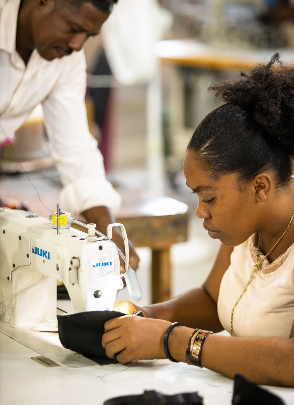 makeup bag in black from fall collection getting handcrafted by our haitian artisans in our solar powered factory in haiti.