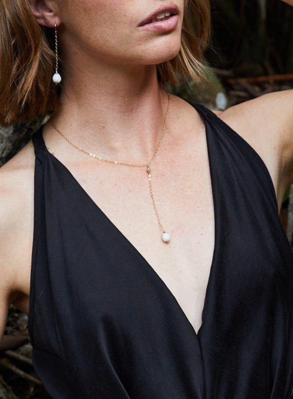marie rose lariat necklace with long drop showcased by model side-view.