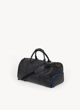 mission essential duffle bag in black with blue stitching and attached strap side-view.