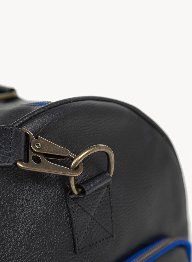 mission essential duffle bag in black with blue stitching close-up-strap-attachment.