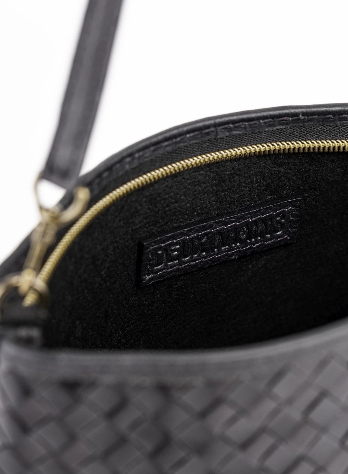 Black textured handbag with a brand logo on a white background