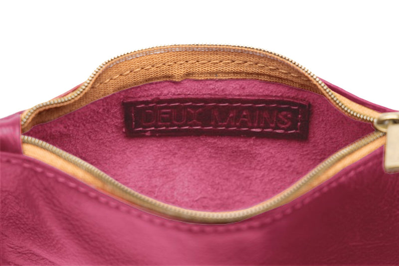 smalll pouch from sustainably hand made accessories in pink showcasing interior view.
