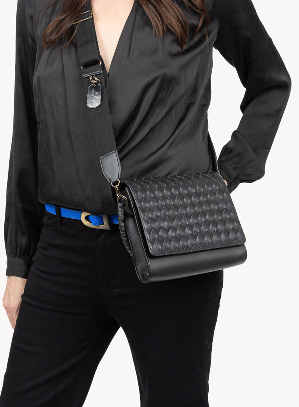 the colonel crossbody in black showcasing side-view of model and bag details.