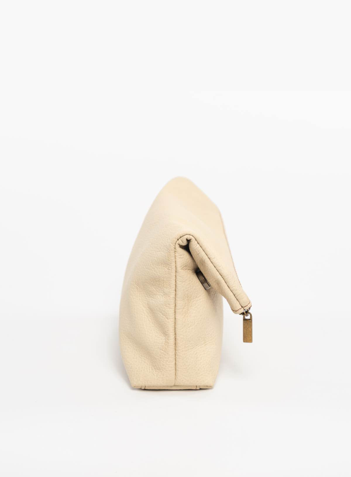 womens sustainable leather makeup bag in bone side view folded over from fall collection.